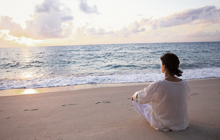 Woman sitting on a beach image
